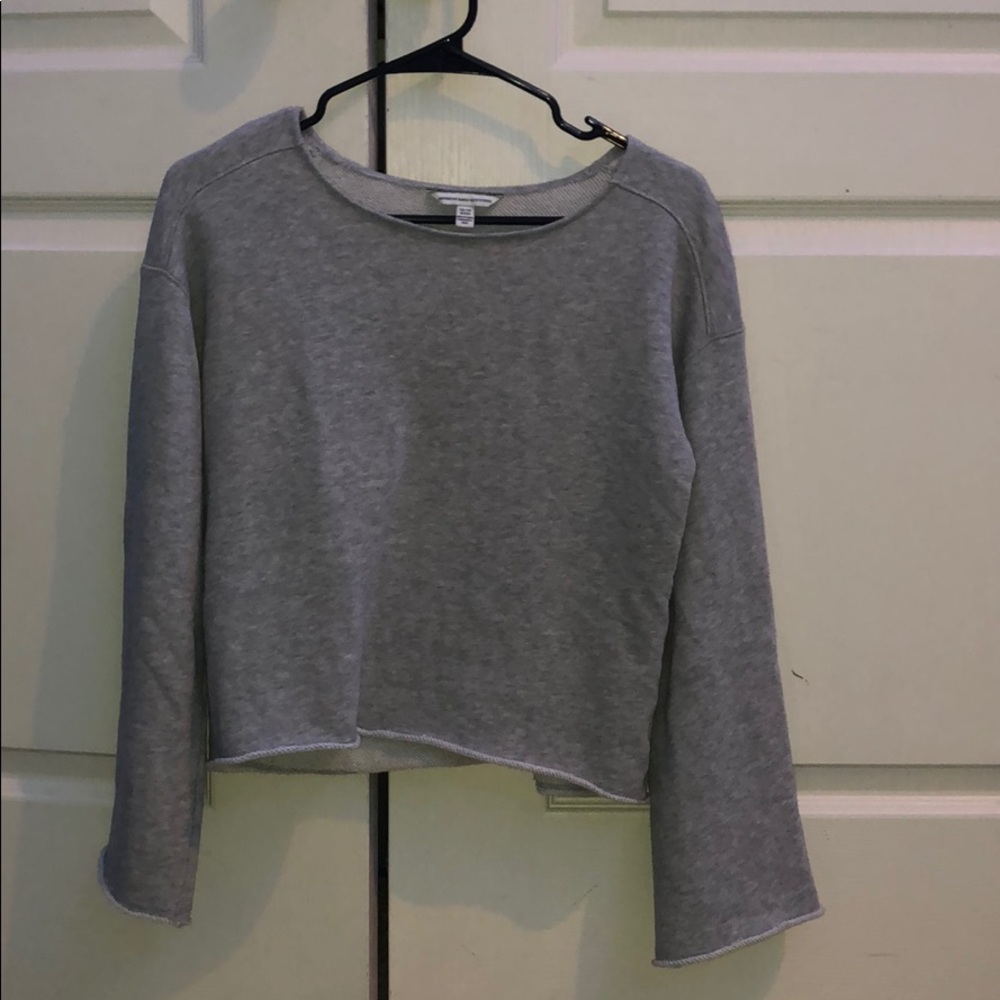 Grey long sleeve crop with open sleeves.